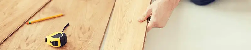 A professional installing wood flooring in Glendale, AZ