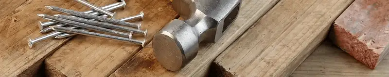 Hammer and nails on hardwood flooring boards in Glendale, AZ