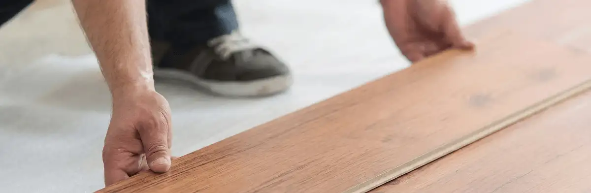 A professional installing laminate flooring in Glendale, AZ