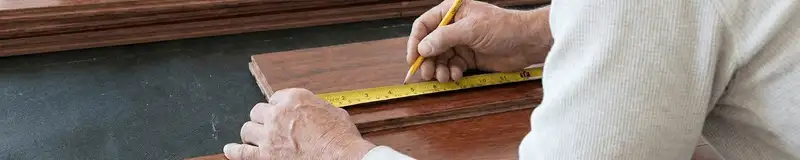 A professional installing wood flooring in Glendale, AZ